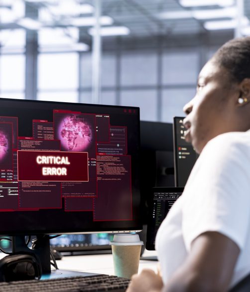 Engineer in server hub investigating breach alerts, working to protect equipment from hacker. Woman in data center employing various tools and technologies to identify and mitigate security risks